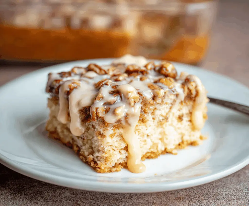 Delicious Butter Pecan Praline Poke Cake topped with pecans and caramel glaze, ready to serve