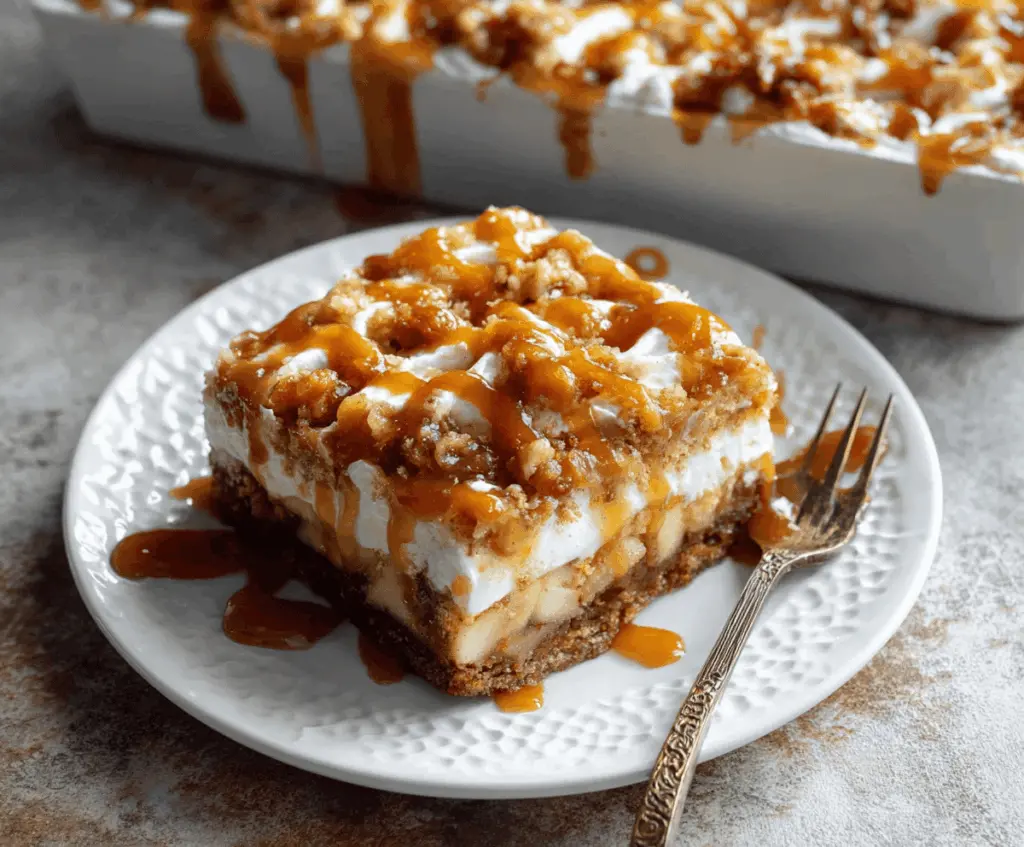Delicious Caramel Apple Poke Cake topped with caramel sauce and apple slices, perfect for fall desserts.
