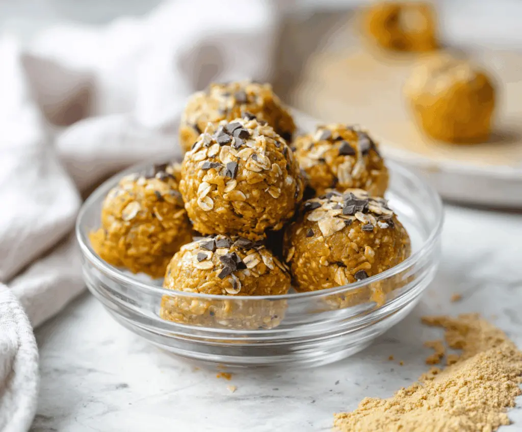 Delicious homemade pumpkin banana protein balls with chia seeds and oats on a white plate, healthy vegan snack option
