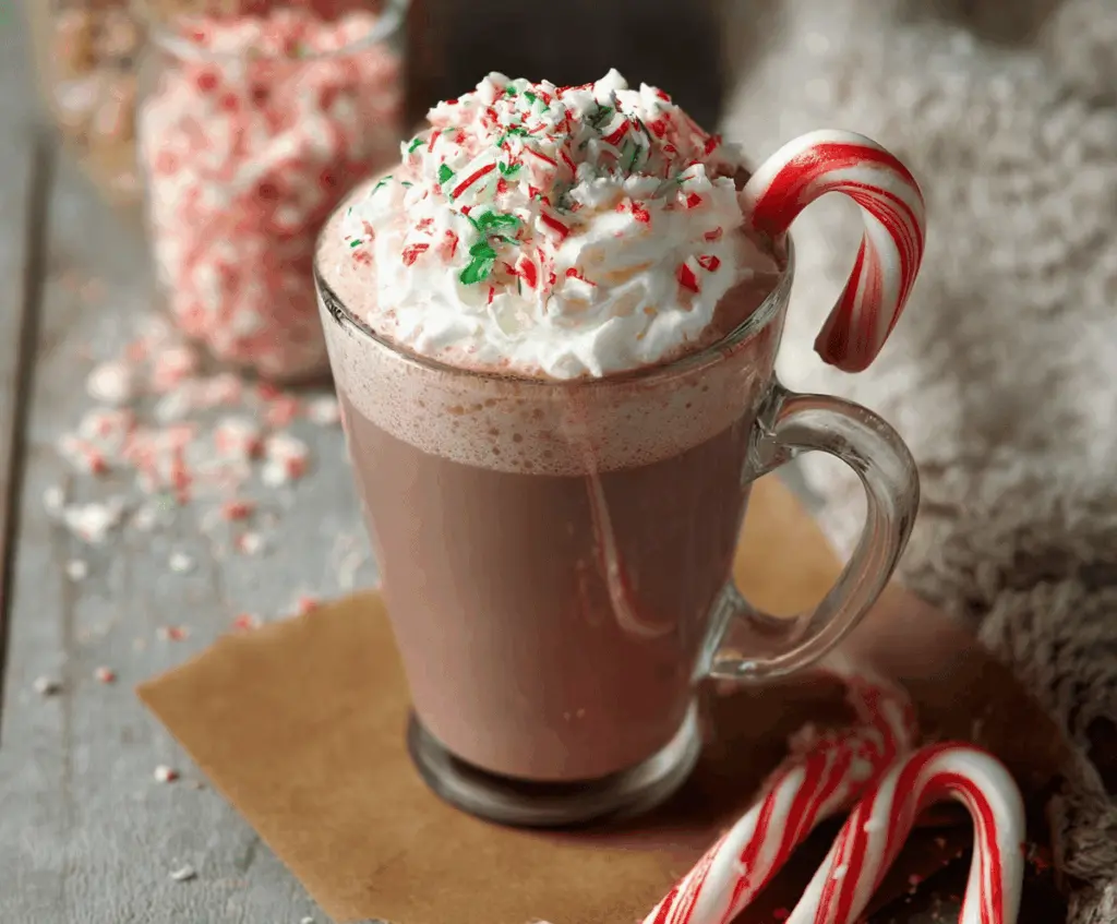 Creamy Candy Cane Hot Chocolate topped with whipped cream and crushed candy canes in a festive mug.
