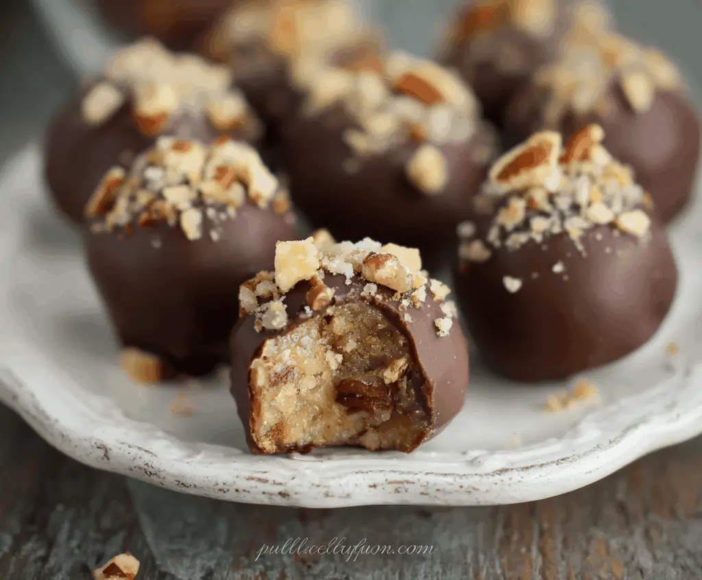 Delicious Pecan Pie Truffles topped with chopped pecans and drizzled chocolate, perfect for dessert.