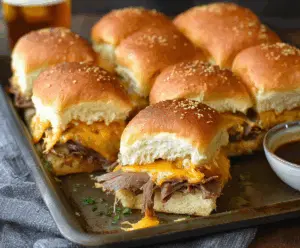 Delicious roast beef and cheddar sliders served on a platter for a hearty appetizer.