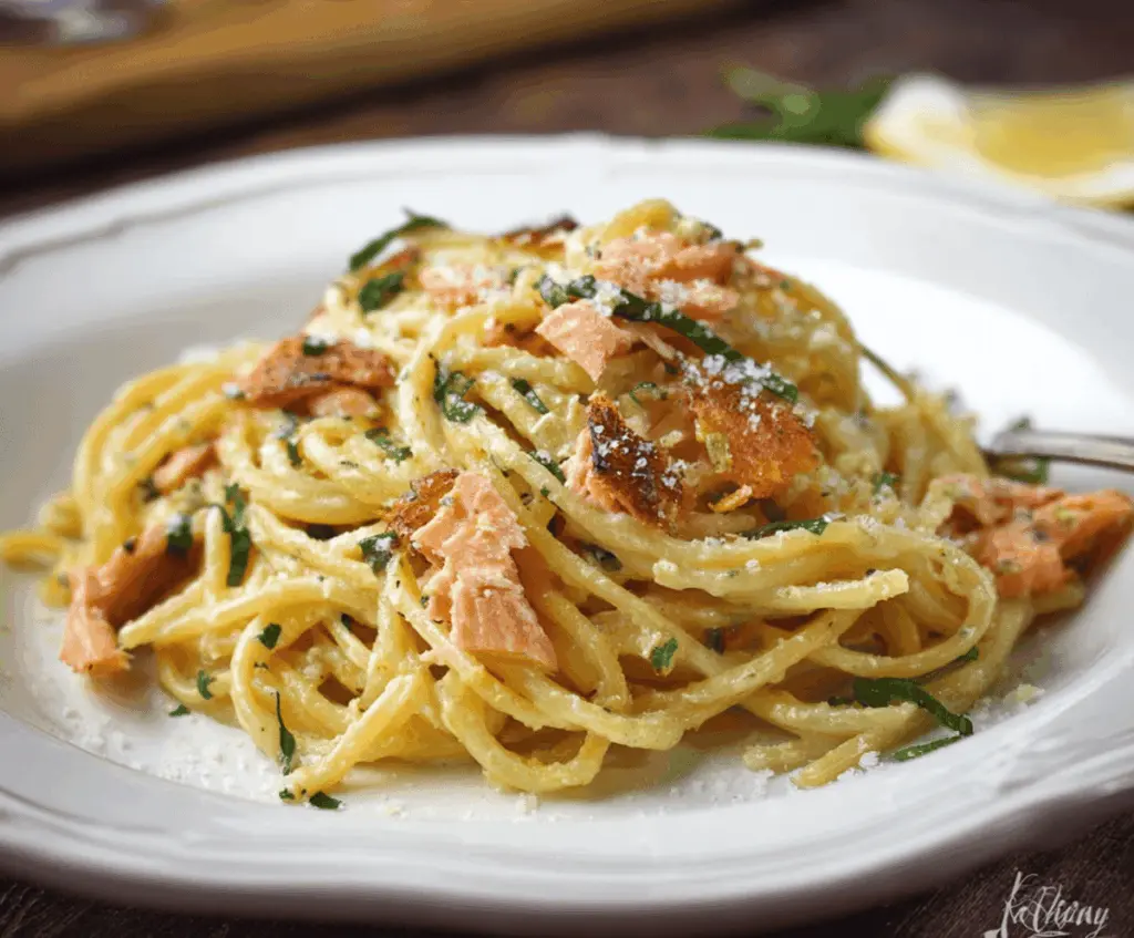 Delicious smoked salmon carbonara pasta with creamy sauce and herbs on a rustic plate