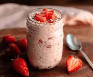 Delicious Strawberry Overnight Oats in a glass jar with fresh strawberries and chia seeds.