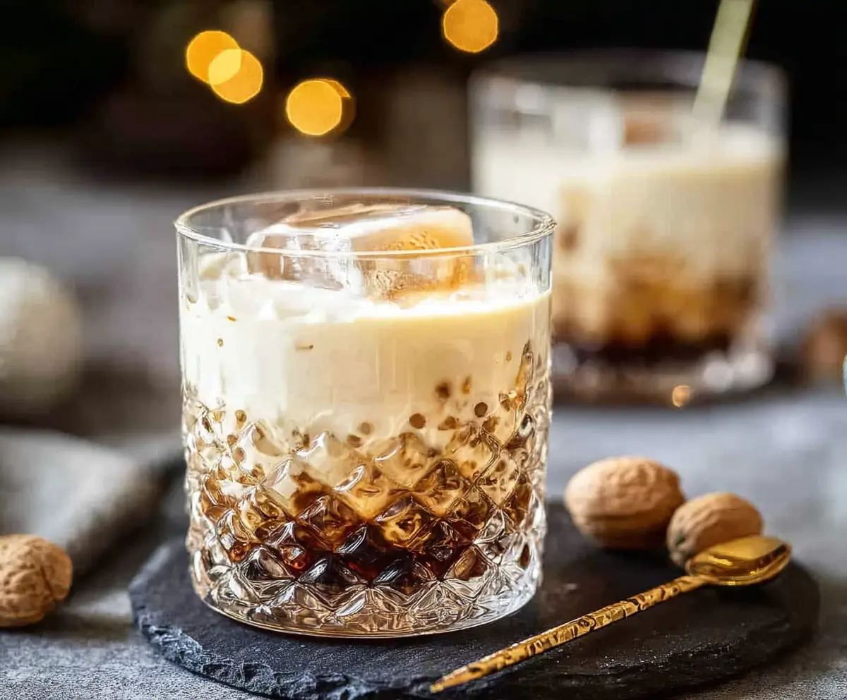 Delicious Peanut Butter White Russian Christmas Cocktail in a festive glass with holiday decorations