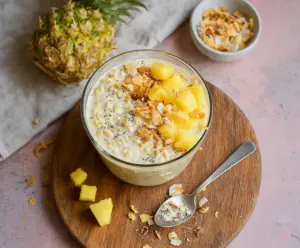 Creamy pineapple overnight oats topped with fresh pineapple chunks and chia seeds in a glass jar