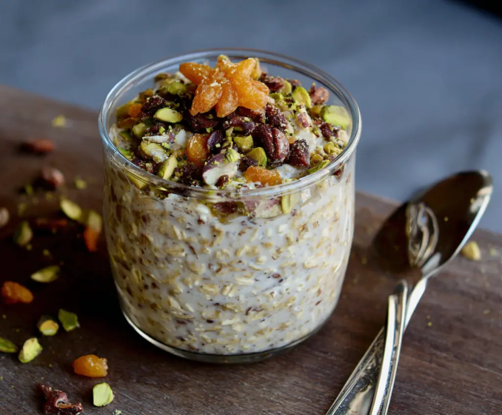 Delicious Baklava Overnight Oats topped with crushed nuts and honey, perfect for a sweet breakfast treat.