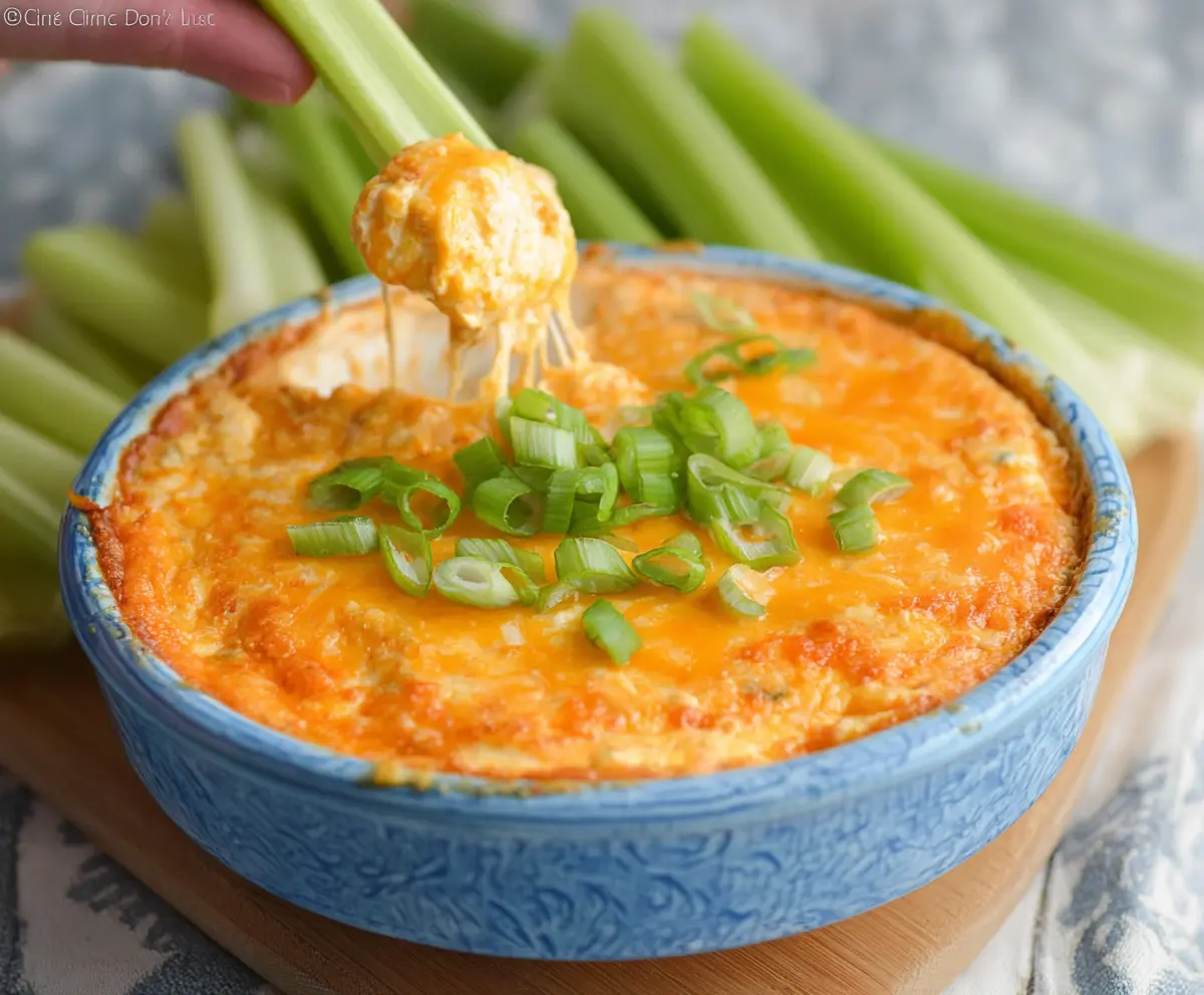 Creamy cheesy buffalo chicken dip served with crackers, perfect for appetizers and parties.