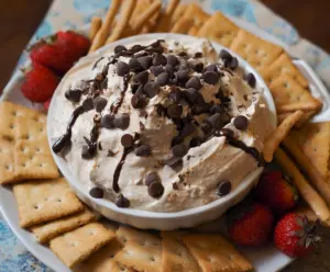 Creamy chocolate chip dessert dip served with fresh fruit and cookies.