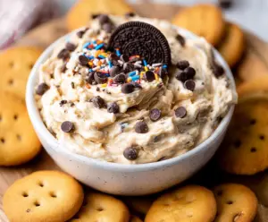Creamy cookie dough dip served with chocolate chips and spoons for dipping
