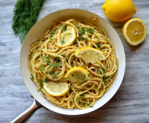 Delicious browned butter lemon dill pasta served on a white plate, garnished with fresh dill and lemon zest.