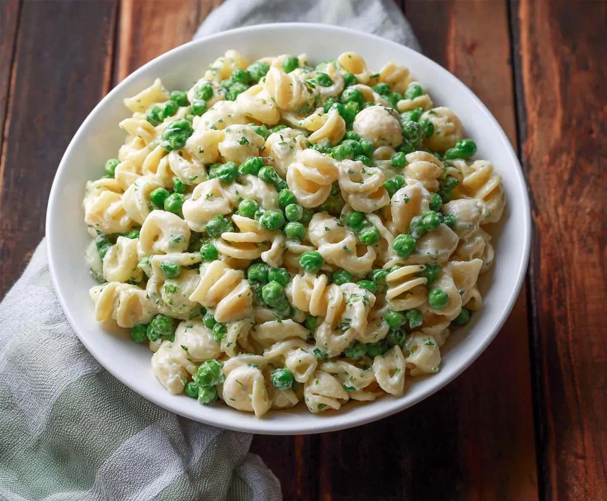 Fresh English Pea Pasta Salad with vibrant vegetables and herbs, perfect for a light summer meal.