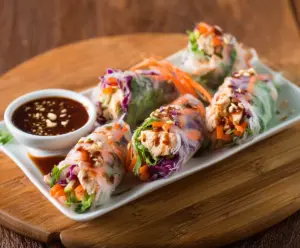 Delicious Teriyaki Chicken Rice Paper Rolls with fresh vegetables and sauce.
